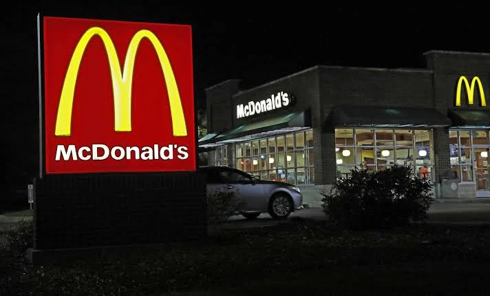 McDonald’s restaurant and golden arches illuminated at night