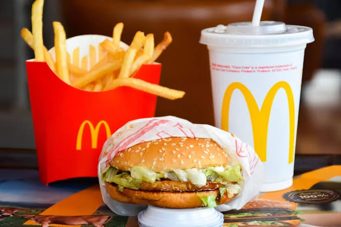 Chicken sandwich, fries, and drink arranged as a meal