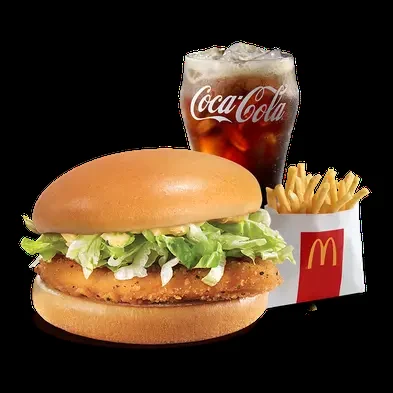 Chicken sandwich with fries and cola on a dark background